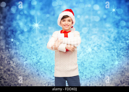 smiling happy boy in santa hat with gift box Stock Photo