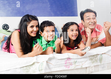 4 People Parents and Kid Bedroom Lying Down Entertainment Television Watching