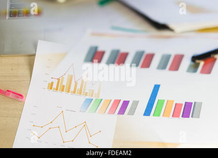 Modern business workplace with tablet, graphs and charts on a desktop. Stock Photo