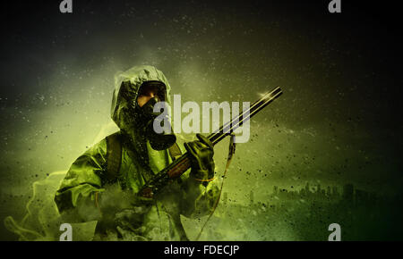Man in gas mask and camouflage holding gun. Disaster concept Stock Photo