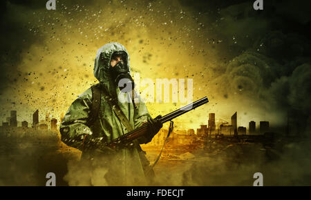 Man in gas mask and camouflage holding gun. Disaster concept Stock Photo