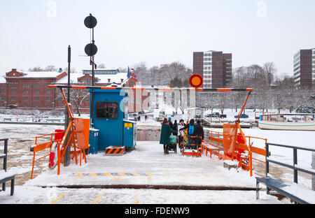 Turku, Finland - January 17, 2016: Ordinary passengers loading on small city boat Fori, light traffic ferry Stock Photo