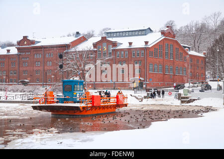 Turku, Finland - January 17, 2016: Ordinary people go on city boat Fori, light traffic ferry that has served the Aura River Stock Photo