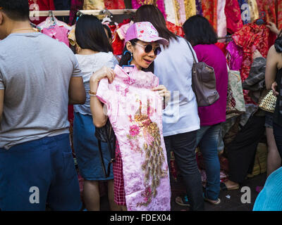 Bangkok, Bangkok, Thailand. 31st Jan, 2016. A woman shops for new clothes at a stand on Yaowarat Road, in Bangkok's Chinatown district, before the celebration of the Lunar New Year. Chinese New Year, also called Lunar New Year or Tet (in Vietnamese communities) starts Monday February 8. The coming year will be the ''Year of the Monkey.'' Thailand has the largest overseas Chinese population in the world; about 14 percent of Thais are of Chinese ancestry and some Chinese holidays, especially Chinese New Year, are widely celebrated in Thailand. © Jack Kurtz/ZUMA Wire/Alamy Live News Stock Photo