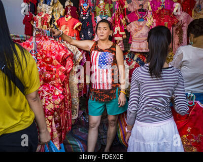 Bangkok, Bangkok, Thailand. 31st Jan, 2016. A woman sells new clothes for Chinese New Year at a stand on Yaowarat Road, in Bangkok's Chinatown district. Chinese New Year, also called Lunar New Year or Tet (in Vietnamese communities) starts Monday February 8. The coming year will be the ''Year of the Monkey.'' Thailand has the largest overseas Chinese population in the world; about 14 percent of Thais are of Chinese ancestry and some Chinese holidays, especially Chinese New Year, are widely celebrated in Thailand. © Jack Kurtz/ZUMA Wire/Alamy Live News Stock Photo