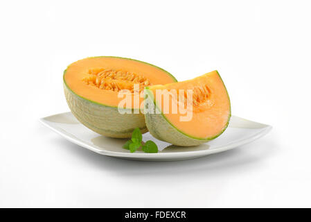 sliced cantaloupe melon on white plate Stock Photo