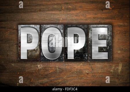 The word 'Pope' written in vintage metal letterpress type on an aged wooden background. Stock Photo