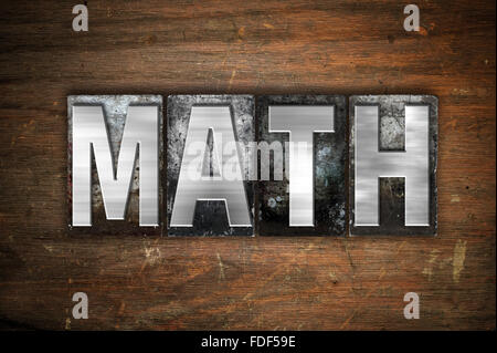 The word "Math" written in vintage metal letterpress type on an aged wooden background. Stock Photo