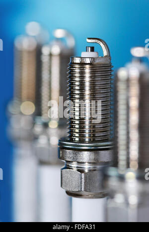 Three new spark plug on a gray background Stock Photo - Alamy