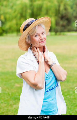 senior healthy old woman practicing yoga and tai chi outdoor Stock Photo