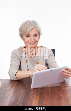 old senior woman using tablet for surfing internet Stock Photo