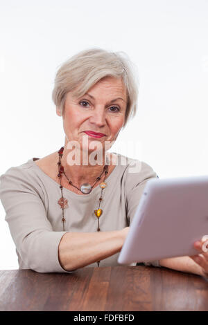 old senior woman using tablet for surfing internet Stock Photo
