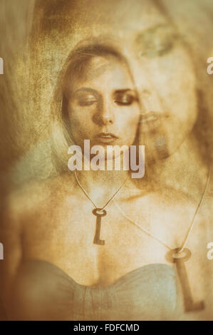 Double exposure portrait of a young woman wearing a key necklace with her eyes closed Stock Photo