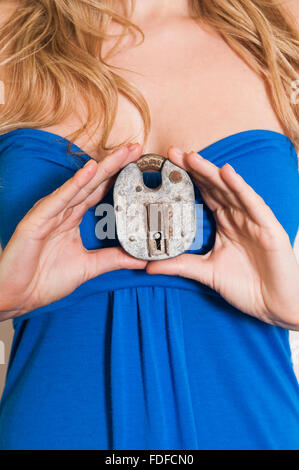 Close up of a woman holding an old padlock Stock Photo