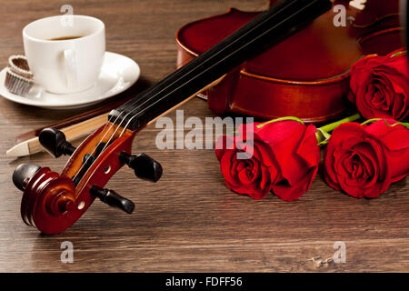 Red roses and a violin on the table Stock Photo