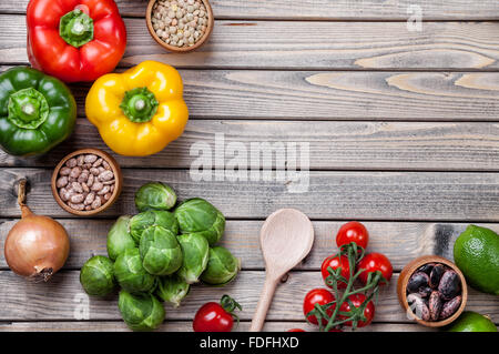 Various vegetables fruits and herbs on wooden background Stock Photo