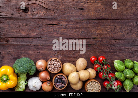 Fresh and healthy organic vegetables and food ingredients on wooden background Stock Photo