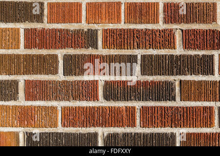 Multi coloured brick wall background and texture. Different bricks can be seen with groves and cement between them, Stock Photo