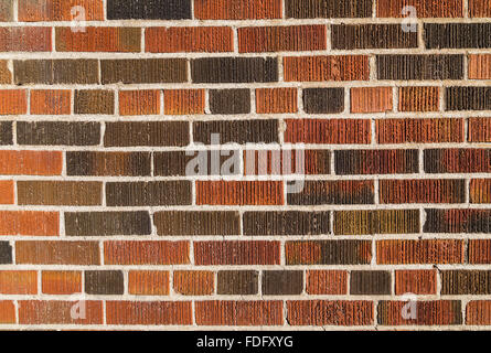 Multi coloured brick wall background and texture. Different bricks can be seen with groves and cement between them, Stock Photo