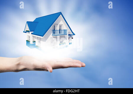 Human hands holding model of dream house Stock Photo - Alamy