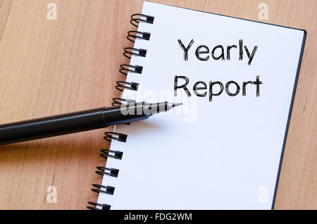 Yearly report text concept write on notebook with pen Stock Photo