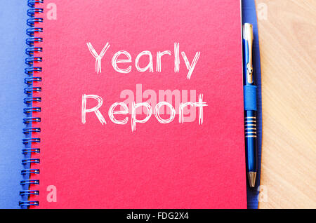 Yearly report text concept write on notebook with pen Stock Photo