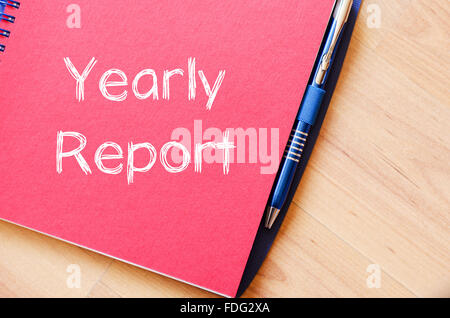 Yearly report text concept write on notebook with pen Stock Photo