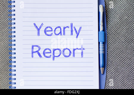 Yearly report text concept write on notebook with pen Stock Photo