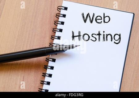 Web hosting text concept write on notebook with pen Stock Photo