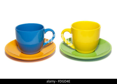Colored teacups and saucers isolated on white. Stock Photo