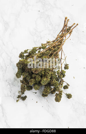 Dried thyme herb on marble background Stock Photo
