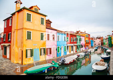 BURANO, ITALY - NOVEMBER 23: Brightly painted houses at the Burano canal on November 23, 2015 in Burano, Venice, Italy. Stock Photo