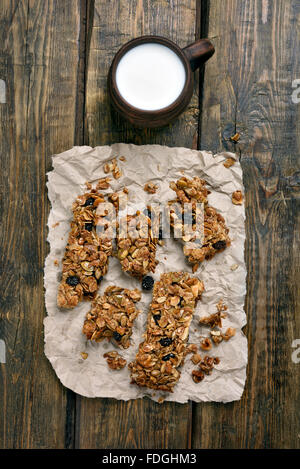 Muesli and cup of milk on wooden background, top view Stock Photo
