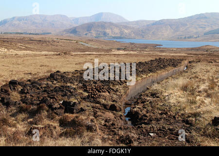 Peat bog and piles of cut turf drying in the sunshine.  County Donegal, Ireland. Stock Photo