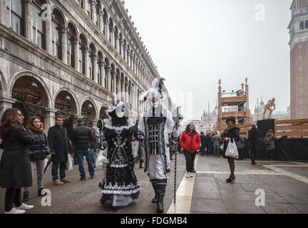 A couple dressed in back and white medieval clothes at the carnival in Venice Italy Stock Photo