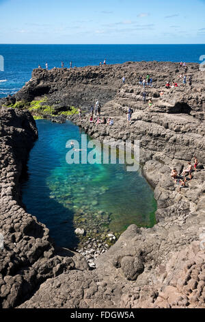 Vertical view of tourists swimming in the lagoon at Olho Azul, the Blue Eye, at Buracona Stock Photo