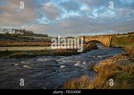 Cadover Bridge, a bridge over The River Plym on Dartmoor in Devon taken just after sunrise on a frosty January morning. Stock Photo