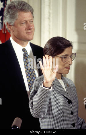 Washington, DC., USA, 10th August,1993 Ruth Bader Ginsberg is Sworn in as Associate Justice of the Supreme Court of the United States. President William Clinton stands behind her as her husband Martin holds the bible as Chief Justice  William H. Rehnquist Administers the Oath of Office. Credit: Mark Reinstein Stock Photo