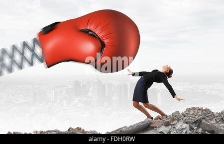 Boxing glove on spring striking businesswoman down Stock Photo ...