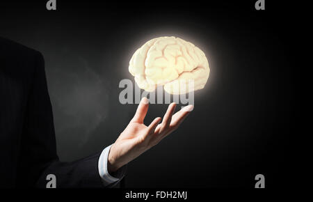 Businessman holding image of human brain in palm Stock Photo - Alamy