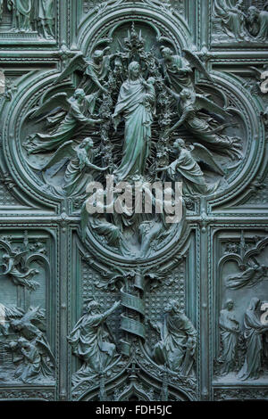 Assumption of the Virgin Mary. Detail of the main bronze door of the Milan Cathedral (Duomo di Milano) in Milan, Italy. Saint Jo Stock Photo