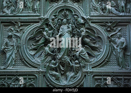 Assumption of the Virgin Mary. Detail of the main bronze door of the Milan Cathedral (Duomo di Milano) in Milan, Italy. Evangeli Stock Photo