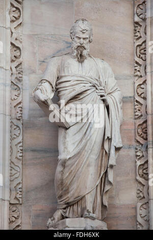 Saint Matthew the Evangelist. Marble statue by Italian sculptor Angelo Pizzi on the main facade of the Milan Cathedral (Duomo di Stock Photo