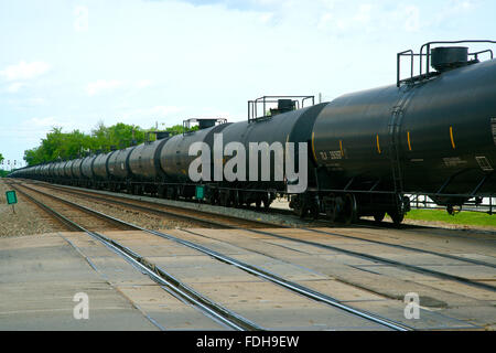 Emporia, Kansas, USA, 14th May,2014 Some of the five thousand tank cars that Warren Buffet bought for his Burlington Northern Santa Fe railroad to transport the oil from the North Dakota Bakken Oil fields pass through  Emporia today. This one train was made up of over a hundred cars, and is just one of the average 87 trains that passes though Emporia, Kansas daily.  The BNSF Railway is the second-largest freight railroad network in North America, second to the Union Pacific Railroad. Credit: Mark Reinstein Stock Photo