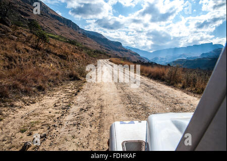 Land Rover Defender driving down a dirt road in Sani pass between South Africa and Lesotho Stock Photo