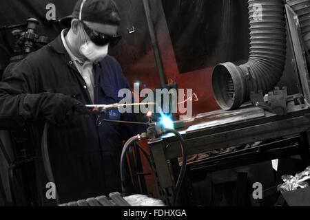 Welder at work in factory Stock Photo