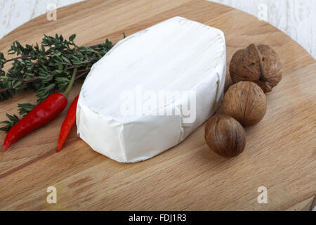 Brie cheese with thyme leaves and nuts Stock Photo