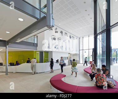 View through double-height entrance foyer with reception and information desk. 5 Pancras Square, London, United Kingdom. Archite Stock Photo