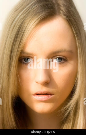 A 16 year old pretty caucasian girl shows a facial expression of Stock ...