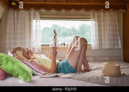 Beautiful woman in a camper van Stock Photo